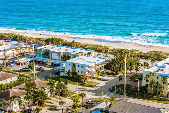 drone / aerial view featuring a beach view and a water view