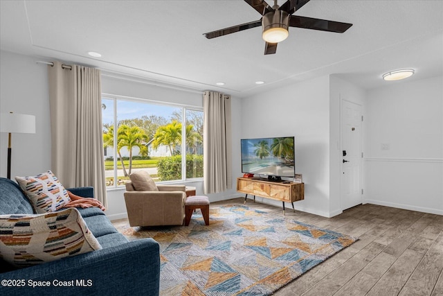 living room featuring ceiling fan and light hardwood / wood-style floors