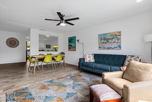 living room with ceiling fan and hardwood / wood-style flooring