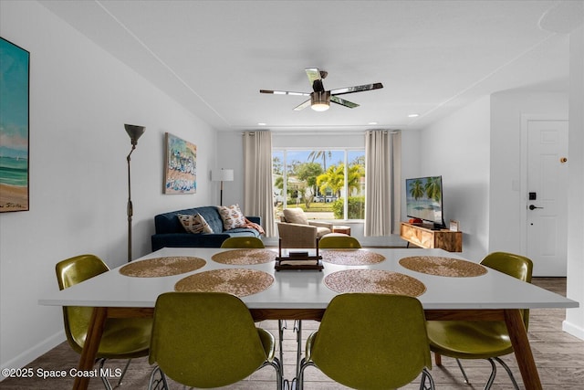 dining space featuring hardwood / wood-style floors and ceiling fan