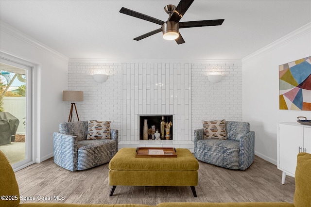 living area with ceiling fan, light hardwood / wood-style floors, and crown molding