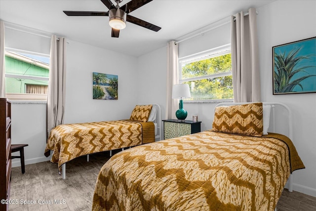 bedroom with hardwood / wood-style flooring and ceiling fan