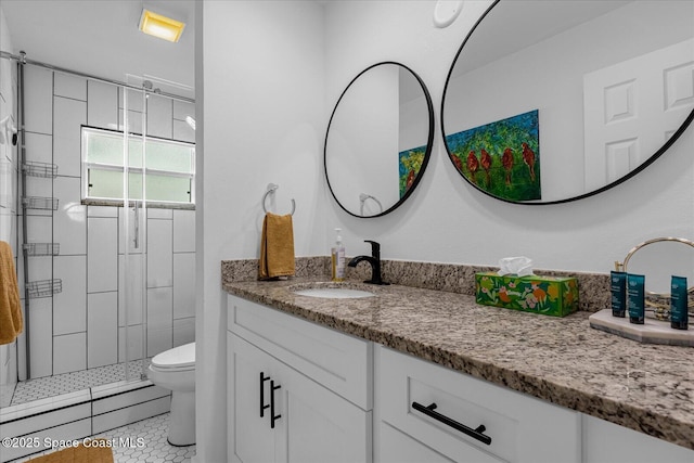 bathroom featuring tiled shower, tile patterned flooring, vanity, and toilet