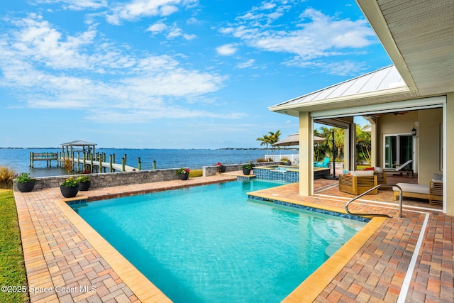 view of swimming pool featuring a water view, an outdoor living space, an in ground hot tub, and a patio