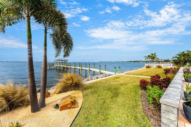 dock area featuring a water view and a yard