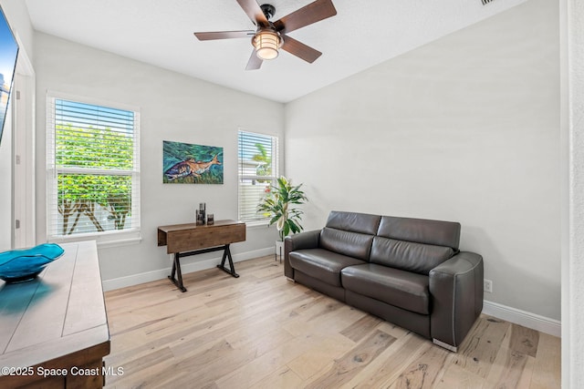 living room with ceiling fan and light hardwood / wood-style floors