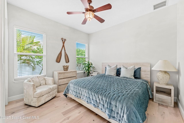 bedroom featuring light hardwood / wood-style floors and ceiling fan