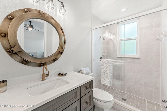 bathroom with walk in shower, vanity, and toilet