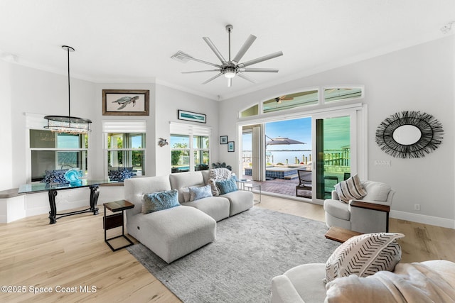 living room with crown molding, ceiling fan, and light hardwood / wood-style floors