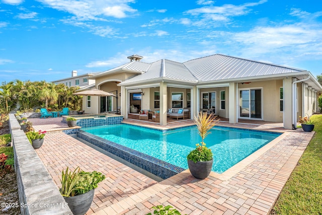 view of swimming pool featuring an in ground hot tub, ceiling fan, an outdoor living space, and a patio area