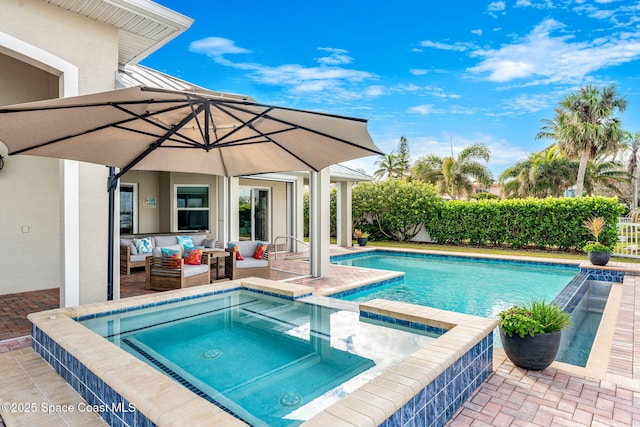 view of pool featuring an in ground hot tub, an outdoor hangout area, and a patio area