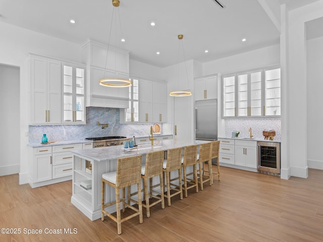 kitchen with wine cooler, appliances with stainless steel finishes, and white cabinetry