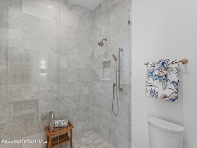 bathroom with tiled shower and toilet