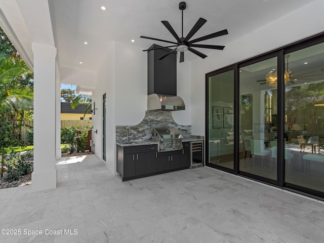 view of patio / terrace with grilling area, beverage cooler, area for grilling, a ceiling fan, and a sink