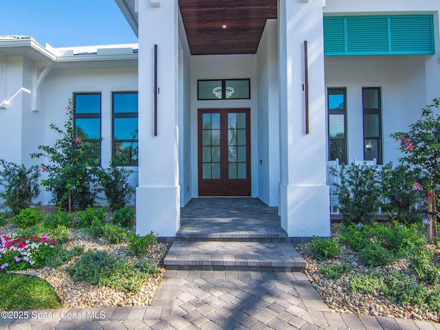 entrance to property with stucco siding and french doors