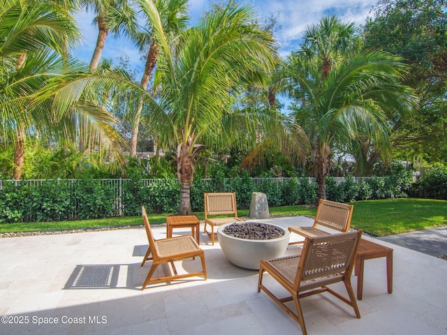 view of patio / terrace featuring a fire pit and fence