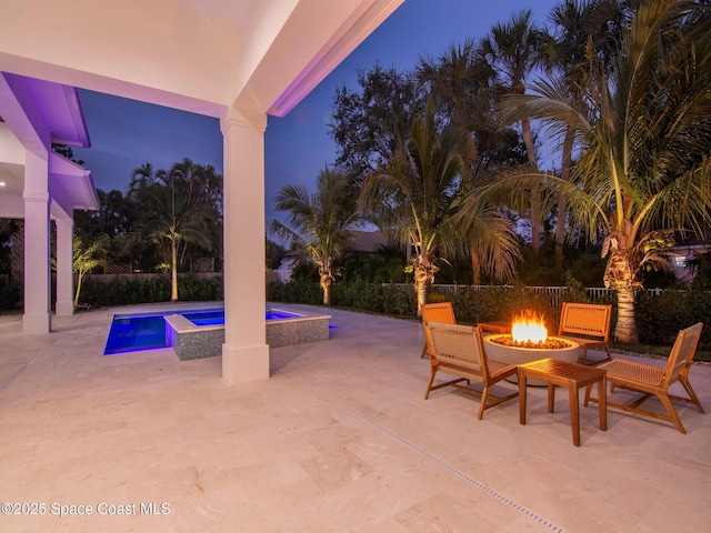 view of patio / terrace with a fenced in pool and an outdoor fire pit