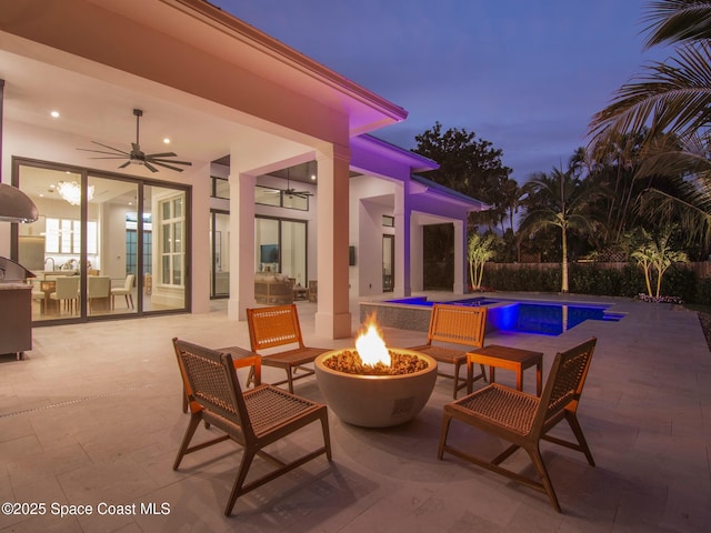 view of patio with area for grilling, a fenced in pool, a fire pit, and ceiling fan