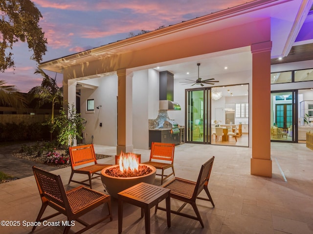 view of patio featuring a fire pit and a ceiling fan