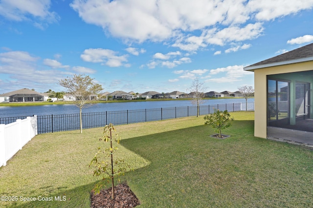 view of yard featuring a water view and a sunroom