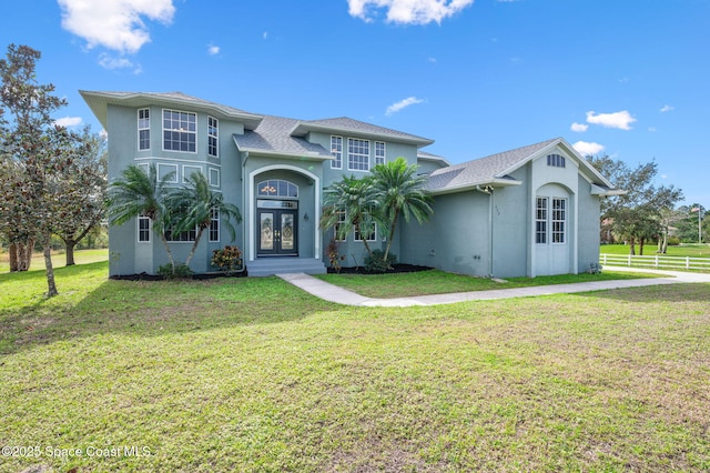 view of front of property featuring a front lawn and french doors