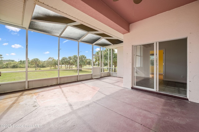 unfurnished sunroom with ceiling fan