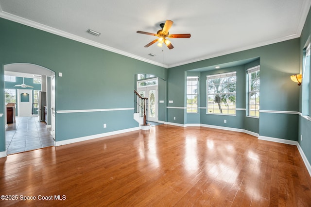 unfurnished room featuring hardwood / wood-style floors, ceiling fan, and crown molding