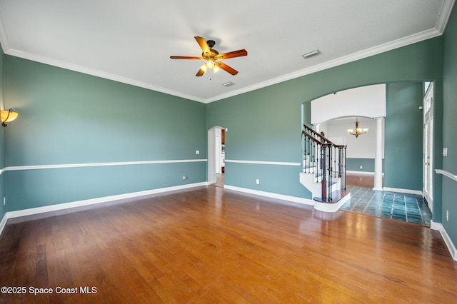 unfurnished room with hardwood / wood-style floors, ceiling fan with notable chandelier, and crown molding