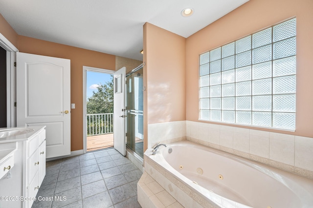 bathroom with tile patterned flooring, vanity, and shower with separate bathtub