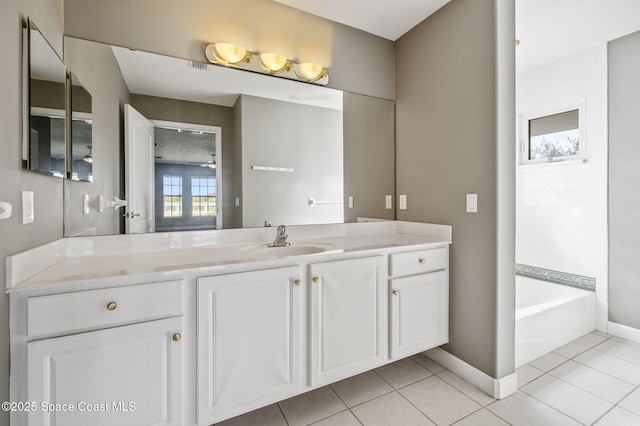 bathroom featuring vanity, a tub to relax in, and tile patterned floors