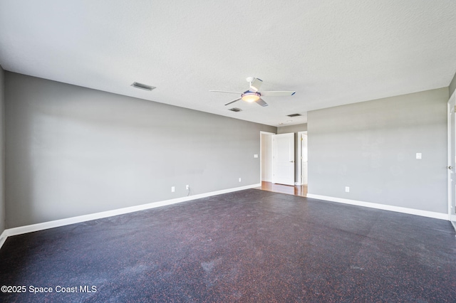 unfurnished room with ceiling fan and a textured ceiling