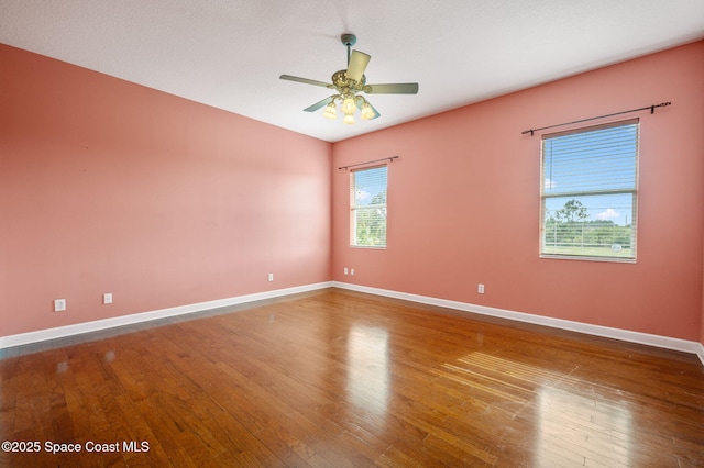 spare room featuring hardwood / wood-style floors and ceiling fan