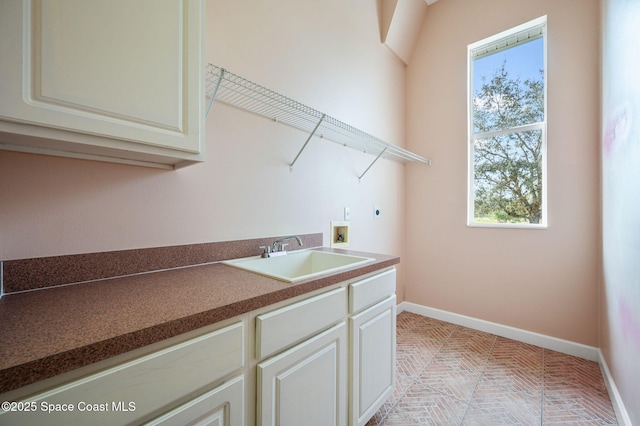 laundry room featuring cabinets, washer hookup, electric dryer hookup, and sink