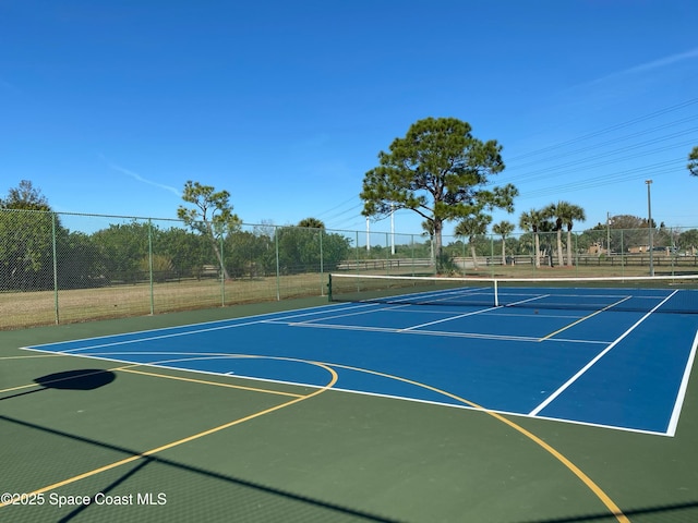 view of tennis court with basketball hoop