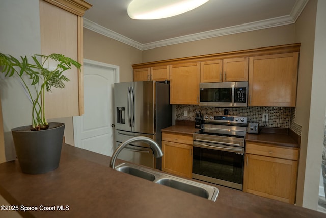 kitchen featuring backsplash, crown molding, sink, and appliances with stainless steel finishes