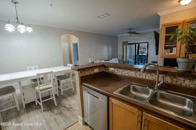 kitchen with sink, hanging light fixtures, tasteful backsplash, stainless steel dishwasher, and ceiling fan with notable chandelier