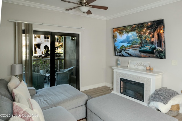 living room featuring hardwood / wood-style flooring, ceiling fan, and ornamental molding