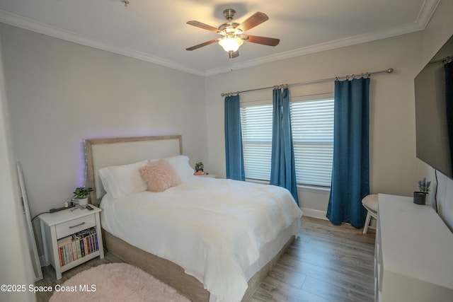 bedroom with light wood-type flooring, ceiling fan, and crown molding