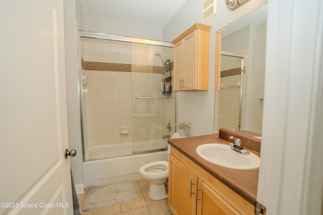 full bathroom with toilet, tile patterned flooring, vanity, and combined bath / shower with glass door