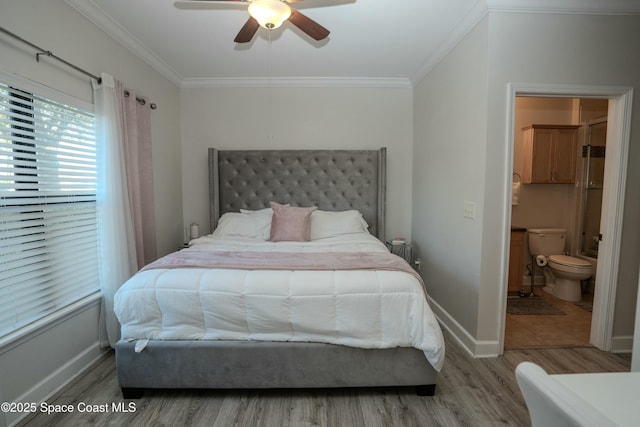 bedroom with hardwood / wood-style flooring, ceiling fan, crown molding, and ensuite bath