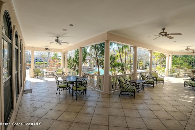 unfurnished sunroom featuring ceiling fan