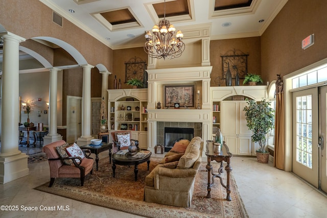 living room featuring ornamental molding, a towering ceiling, coffered ceiling, and a notable chandelier