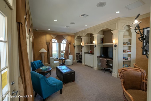 sitting room with built in shelves, light carpet, and ornamental molding