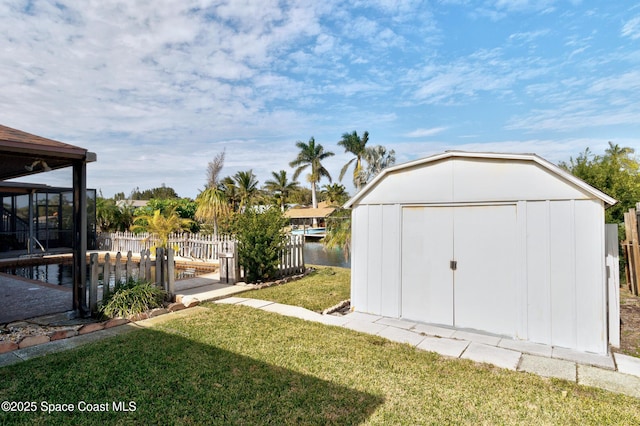 view of yard with a storage unit and a water view