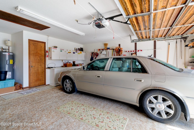 garage with a garage door opener and electric water heater