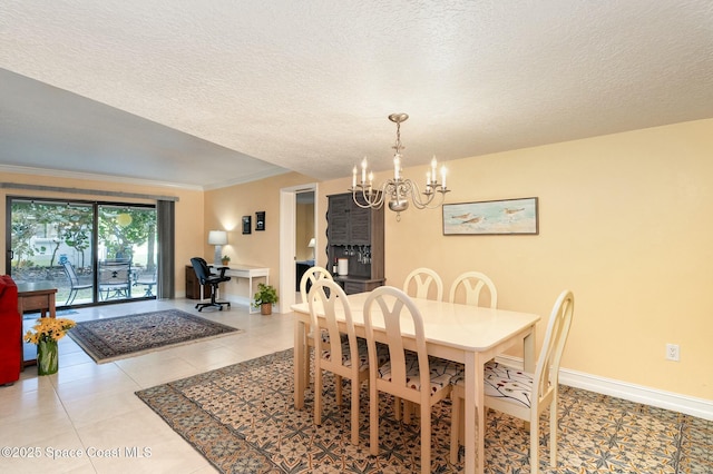 dining space featuring a textured ceiling, light tile patterned floors, ornamental molding, and a notable chandelier