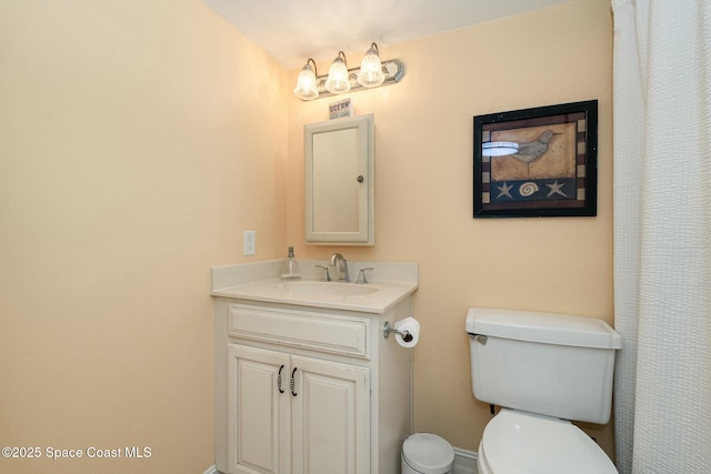 bathroom featuring toilet and vanity