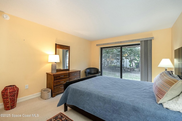 bedroom with light colored carpet and access to exterior