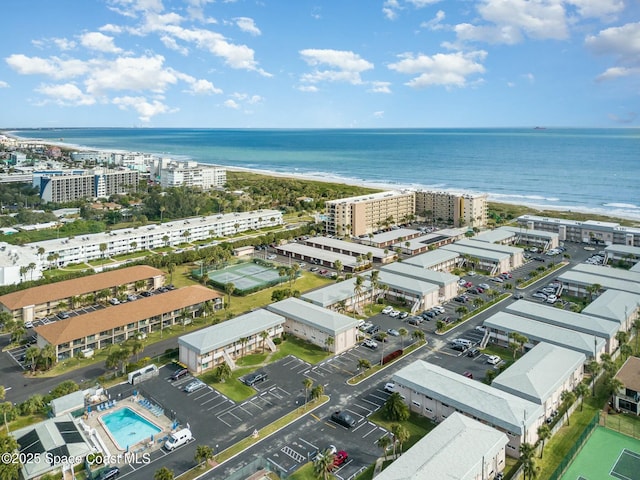 birds eye view of property featuring a water view and a beach view