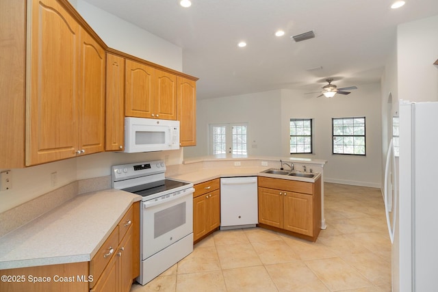 kitchen with ceiling fan, sink, white appliances, and kitchen peninsula